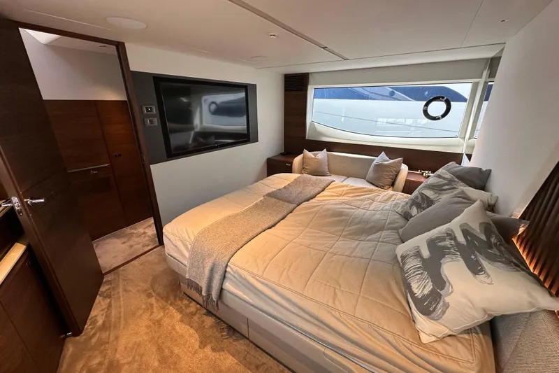 Yacht Photos Pics Luxurious bedroom interior of 2022 Princess Y72 yacht with modern decor and large window.