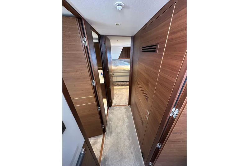  Yacht Photos Pics Luxurious interior hallway of 2022 Princess Y72 yacht with wooden finishes.