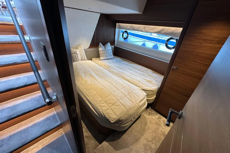 Yacht Photos Pics Luxurious cabin interior of 2022 Princess Y72 yacht with twin beds and elegant wood finish.