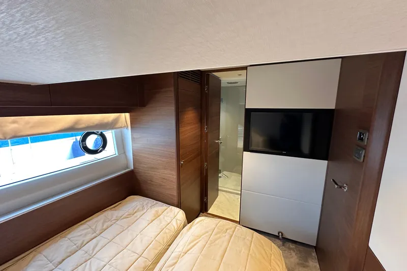  Yacht Photos Pics Luxurious 2022 Princess Y72 yacht cabin with twin beds, TV, and modern decor.
