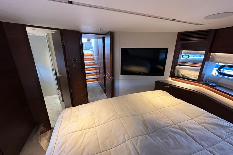  Yacht Photos Pics Luxurious 2022 Princess Y72 yacht bedroom with modern decor and flat-screen TV.