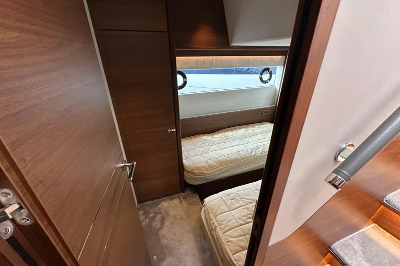  Yacht Photos Pics Interior of 2022 Princess Y72 yacht with twin beds and wooden finish.