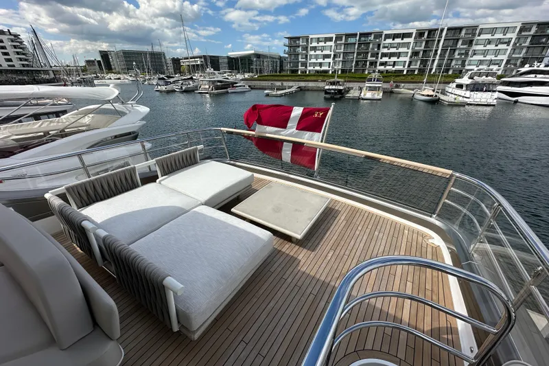 Yacht Photos Pics Luxurious 2022 Princess Y72 yacht deck with sun loungers, docked in a modern marina.