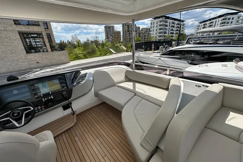  Yacht Photos Pics Luxurious 2022 Princess Y72 yacht interior with modern seating and navigation controls.