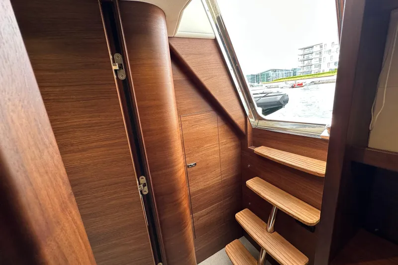  Yacht Photos Pics Interior of 2022 Princess Y72 yacht with wooden stairs and window view.