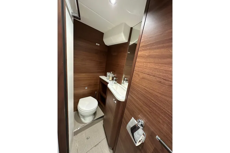  Yacht Photos Pics Luxurious bathroom in 2022 Princess Y72 yacht with wood paneling and modern fixtures.