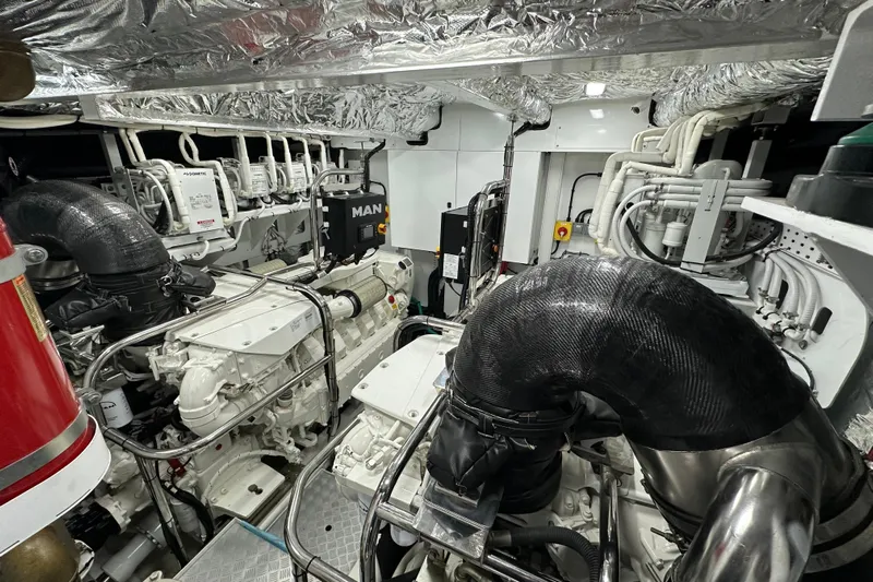  Yacht Photos Pics Engine room of a 2022 Princess Y72 yacht, featuring advanced machinery and piping systems.