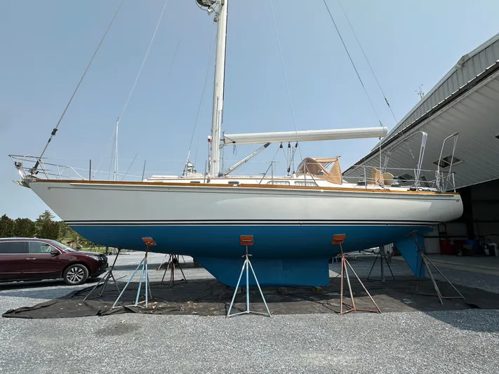 Elusive Yacht Photos Pics 1987 Hinckley Sou'wester 42 sailboat on stands, displayed outdoors near a building.