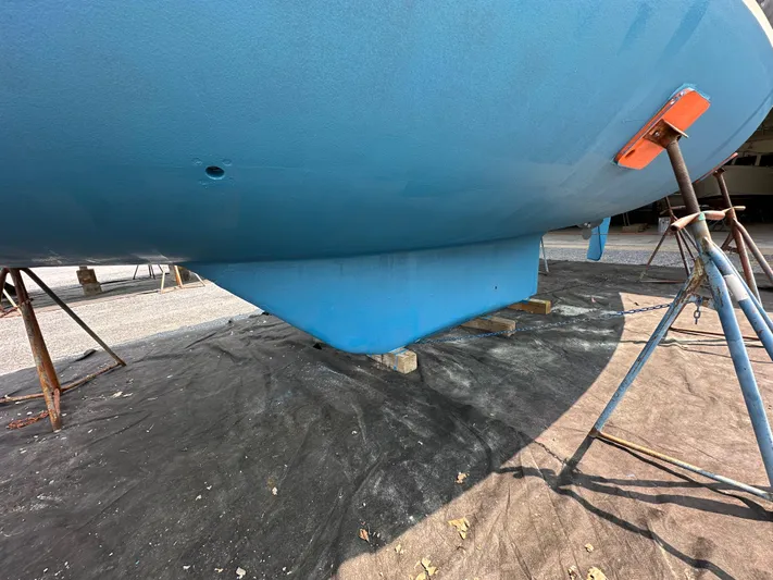 Elusive Yacht Photos Pics 1987 Hinckley Sou'wester 42 sailboat hull on stands, blue finish, outdoor setting.