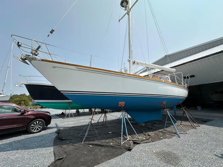 Elusive Yacht Photos Pics 1987 Hinckley Sou'wester 42 sailboat on stands, displayed outdoors near a building.