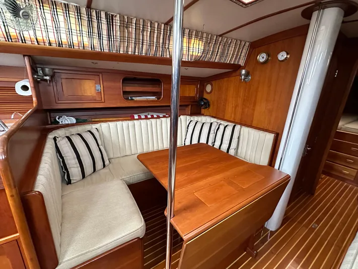 Elusive Yacht Photos Pics Interior of 1987 Hinckley Sou'wester 42 sailboat with wood finish and cozy seating area.