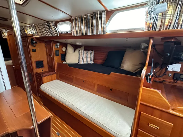 Elusive Yacht Photos Pics Interior of 1987 Hinckley Sou'wester 42 sailboat with wooden furnishings and cozy seating area.