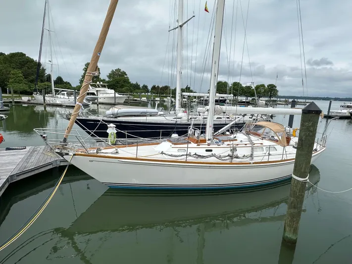 Elusive Yacht Photos Pics 1987 Hinckley Sou'wester 42 sailboat docked in a marina, surrounded by calm waters.