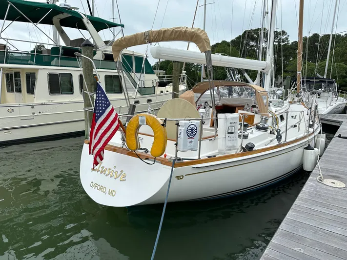 Elusive Yacht Photos Pics Hinckley Sou'wester 42 sailboat, 1987 model, docked with American flag, Oxford, MD.