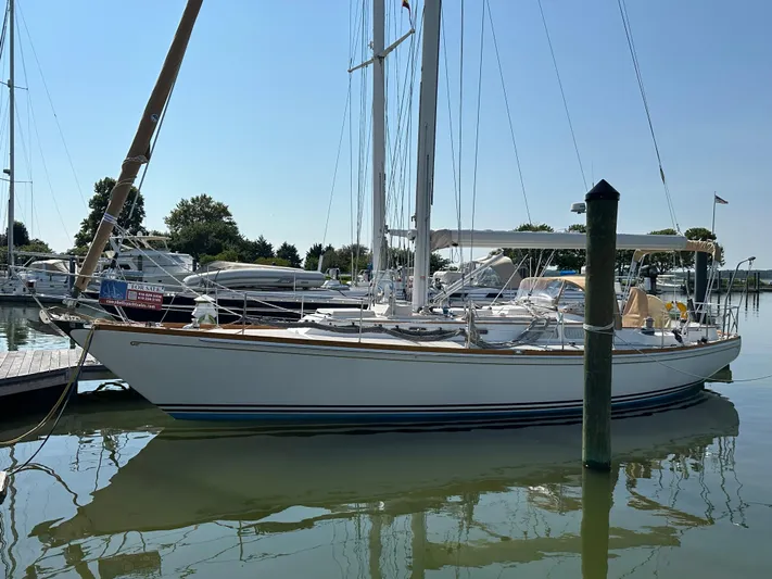 Elusive Yacht Photos Pics 1987 Hinckley Sou'wester 42 sailboat docked at marina, clear sky, calm water.