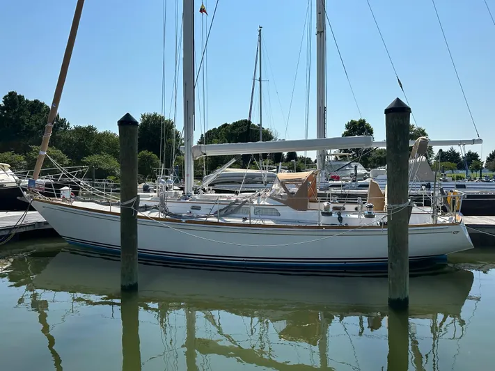Elusive Yacht Photos Pics 1987 Hinckley Sou'wester 42 sailboat docked in a marina under clear skies.
