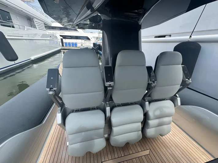 Freebird 42 Yacht Photos Pics Three sleek seats on a 2022 Anvera 42 boat, docked at a marina.