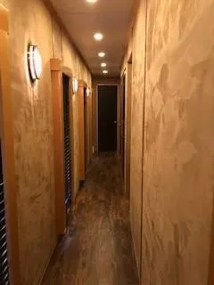 Cruisin (1/5 Share) Yacht Photos Pics Hallway in 2008 Destination Yachts Cruisin, warmly lit, wooden flooring.