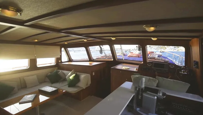 Kaiki Yacht Photos Pics Interior of a 1974 Greek traditional sailing yacht with cozy seating and wooden accents.