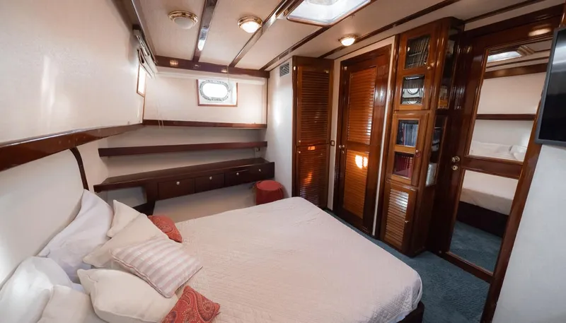 Kaiki Yacht Photos Pics Luxurious cabin interior of a 1974 Greek traditional sailing yacht with wooden accents.