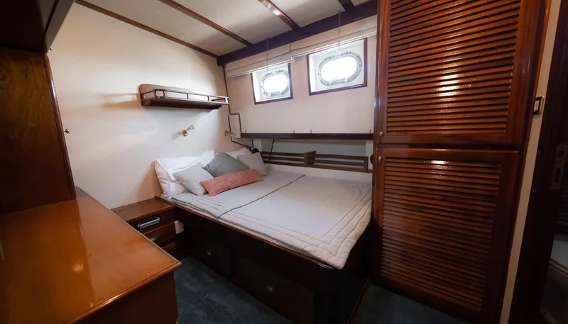 Kaiki Yacht Photos Pics Cozy cabin interior of 1974 Greek traditional sailing yacht with wooden furnishings and porthole windows.