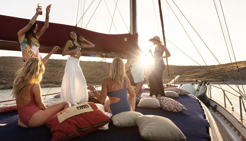 Kaiki Yacht Photos Pics Women enjoying a sunset party on a 1974 Greek traditional sailing yacht.