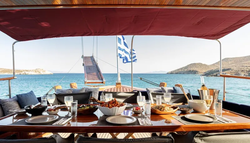 Kaiki Yacht Photos Pics Luxurious dining setup on a 1974 Greek traditional sailing yacht with sea view.
