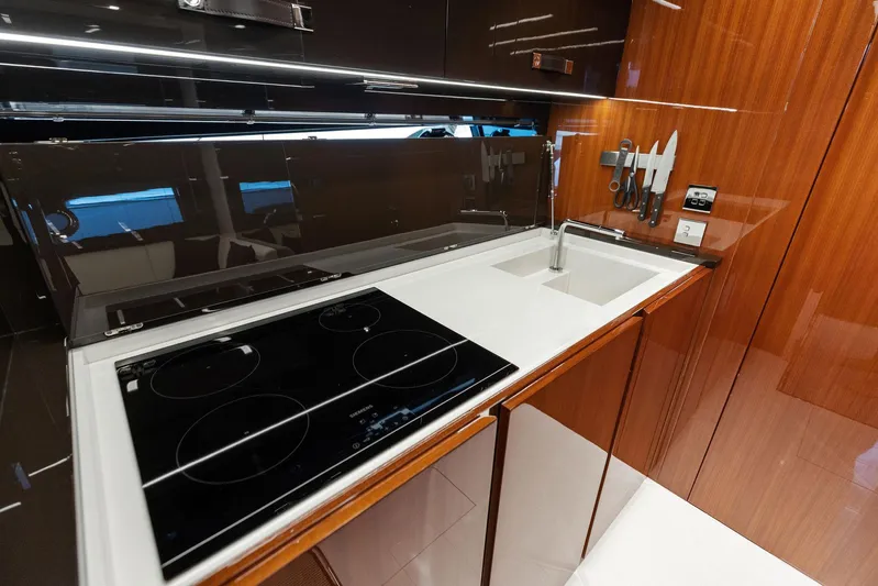  Yacht Photos Pics Modern kitchen in 2023 Riva Rivale 56 Hard Top yacht with sleek design and appliances.