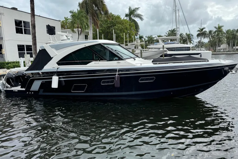 Formula Yacht Photos Pics 2023 Formula 400 Super Sport Crossover yacht docked in a marina with palm trees.