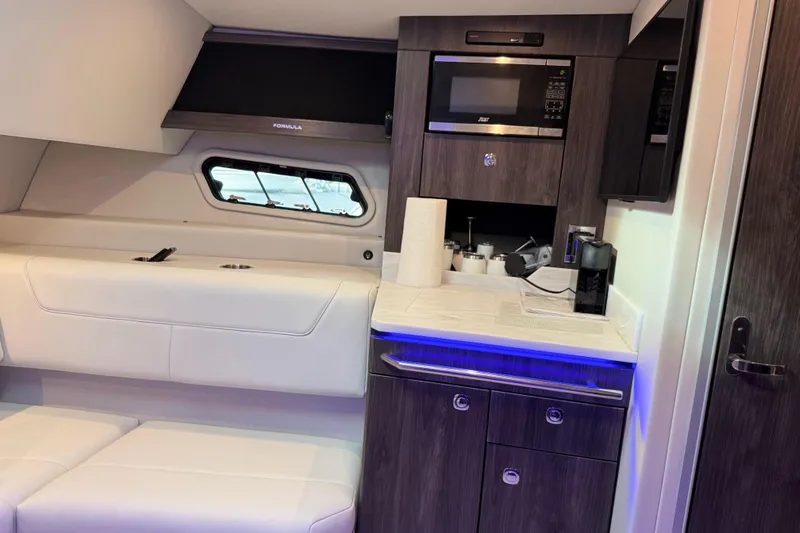Formula Yacht Photos Pics 2023 Formula 400 Super Sport Crossover interior with kitchenette and seating area.