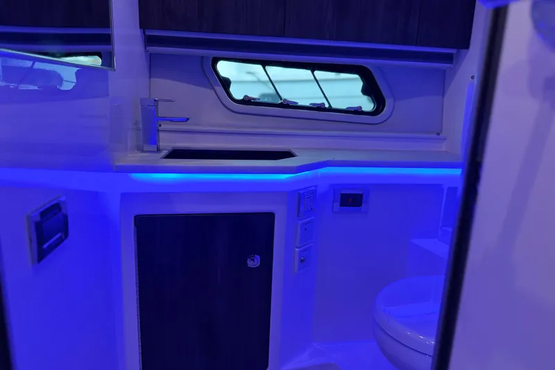 Formula Yacht Photos Pics 2023 Formula 400 Super Sport Crossover bathroom with modern sink and blue LED lighting.