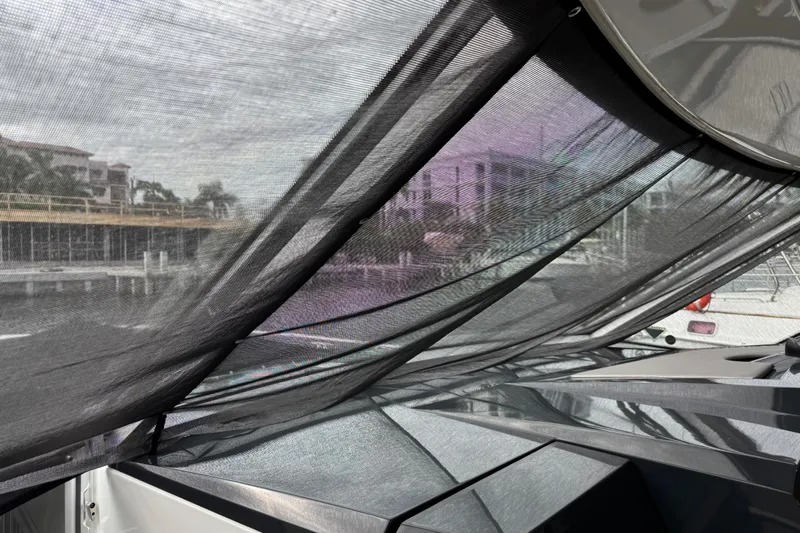 Formula Yacht Photos Pics 2023 Formula 400 Super Sport Crossover with mesh canopy, docked near waterfront buildings.