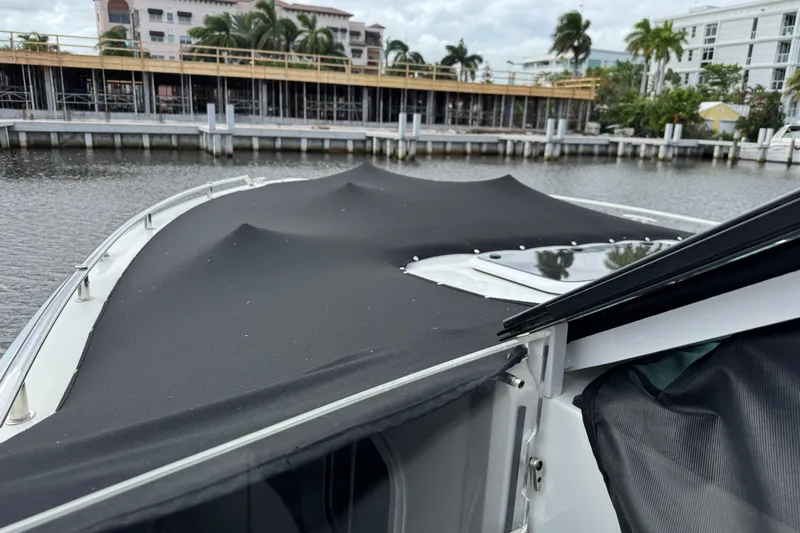 Formula Yacht Photos Pics 2023 Formula 400 Super Sport Crossover boat with black cover docked by waterfront.
