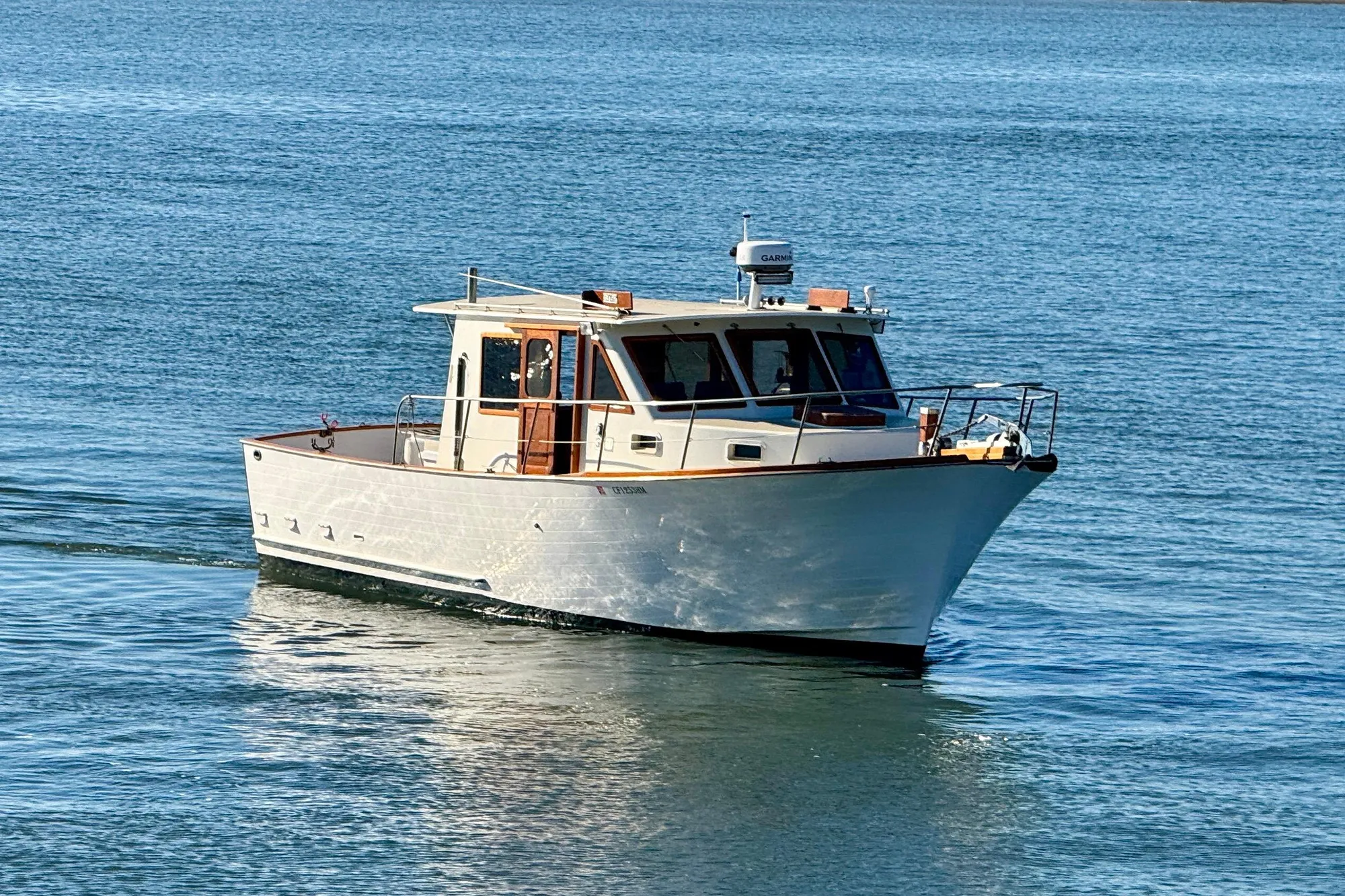 1982 Tung Hwa Seahorse boat cruising on calm blue waters.
