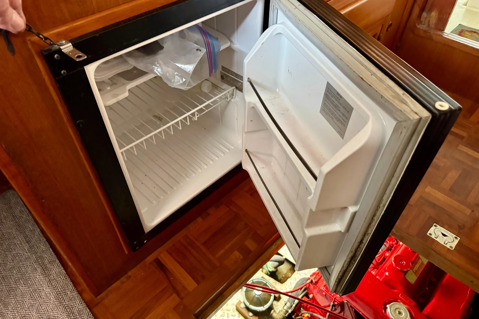 Open refrigerator inside 1982 Tung Hwa Seahorse boat, showcasing interior storage space.