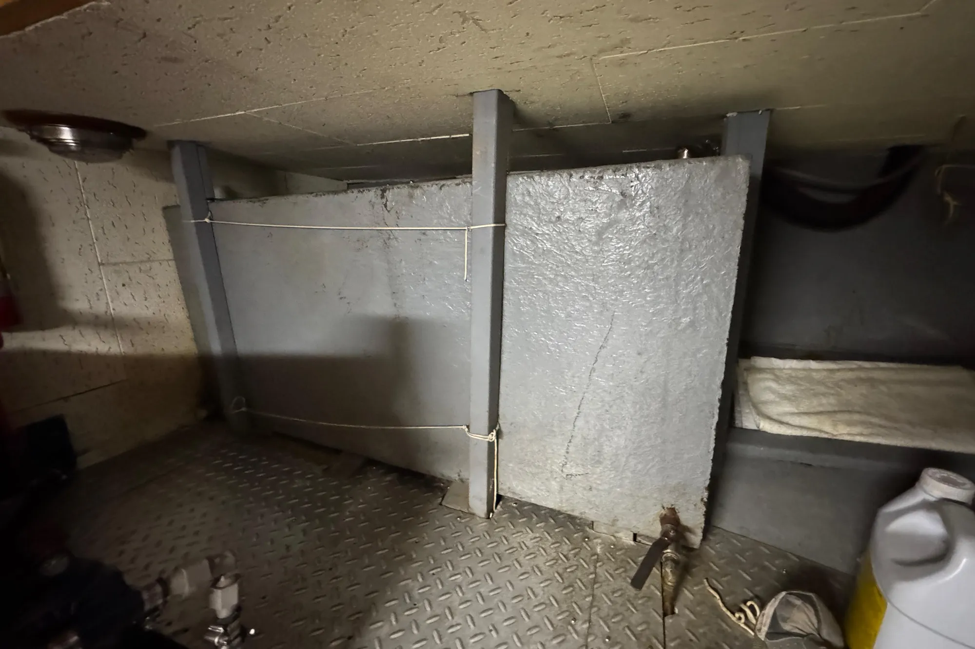 Engine room of 1982 Tung Hwa Seahorse boat with metal components and storage.