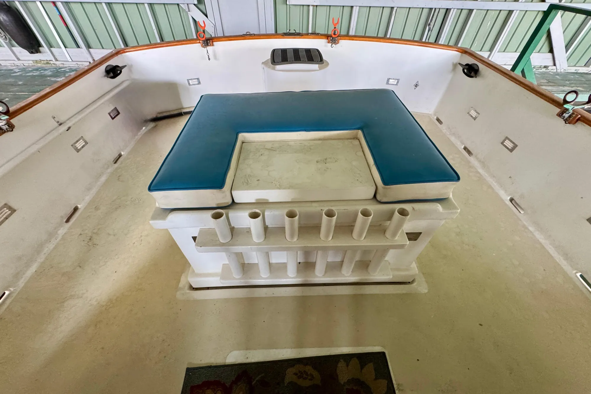 1982 Tung Hwa Seahorse boat deck with blue cushioned seating and rod holders.