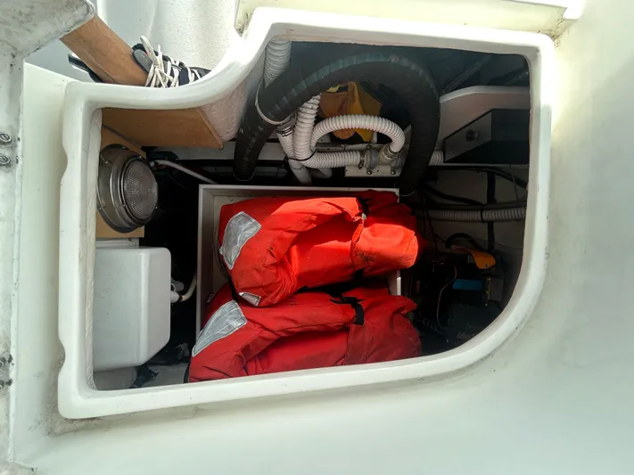 Dream Weaver Yacht Photos Pics Storage compartment in a 2003 Catalina 350 sailboat with life jackets and equipment.