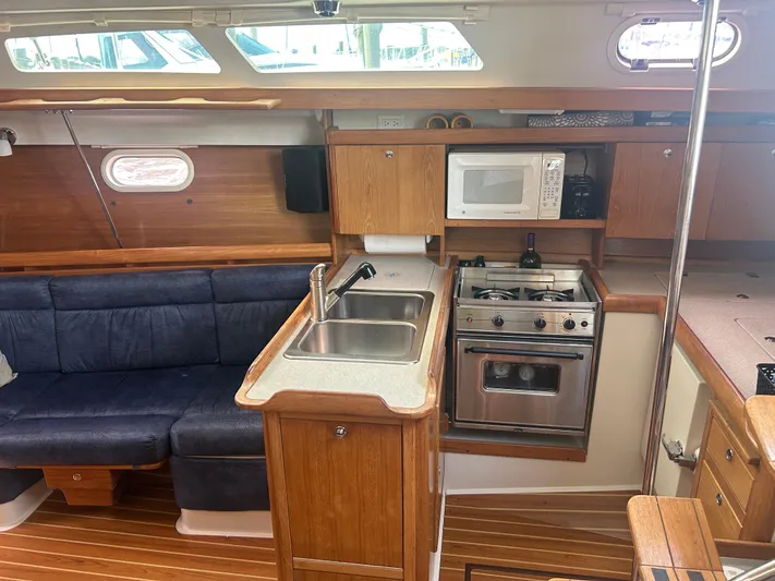 Dream Weaver Yacht Photos Pics Interior of 2003 Catalina 350 sailboat with kitchen and seating area.