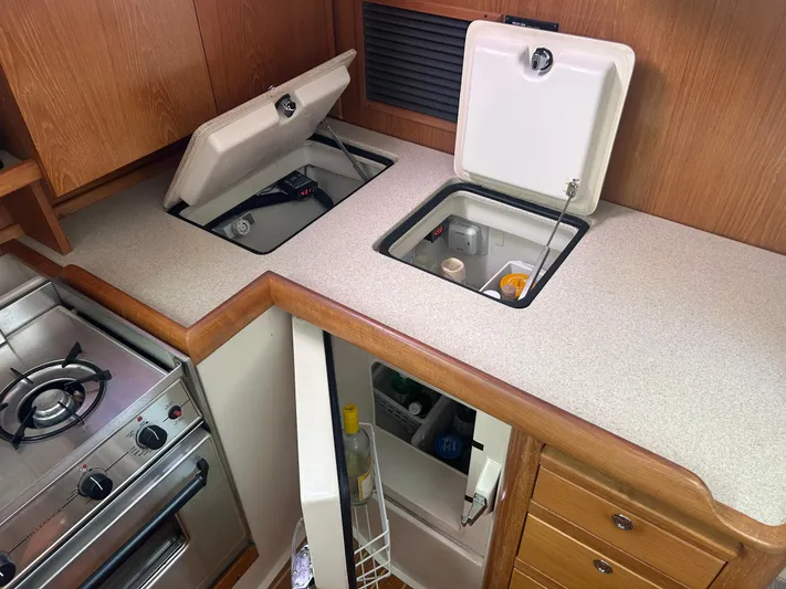 Dream Weaver Yacht Photos Pics Galley kitchen in 2003 Catalina 350 sailboat with stove and storage compartments.