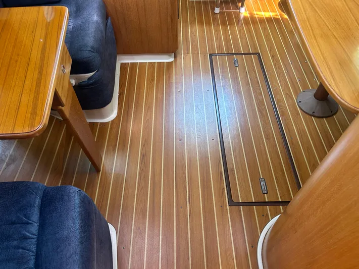 Dream Weaver Yacht Photos Pics Interior of a 2003 Catalina 350 sailboat with wooden flooring and seating area.