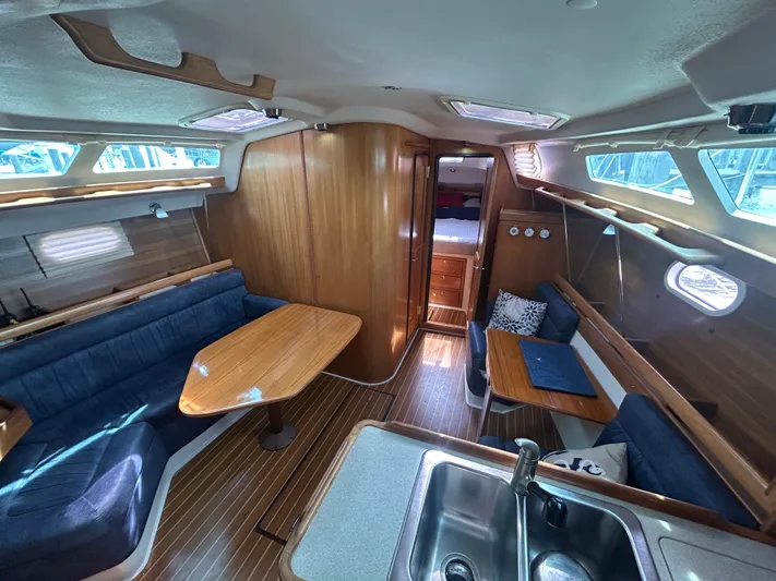 Dream Weaver Yacht Photos Pics Interior of 2003 Catalina 350 sailboat with wood finish and cozy seating area.