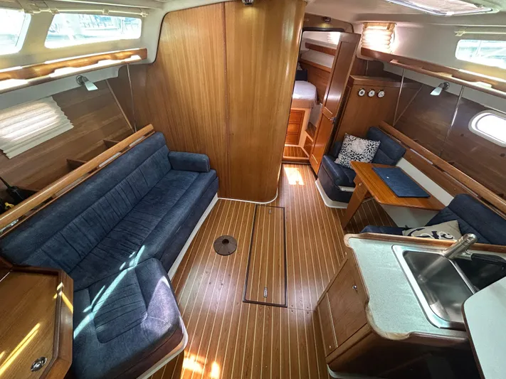 Dream Weaver Yacht Photos Pics Interior of 2003 Catalina 350 sailboat with wood finish and blue seating.