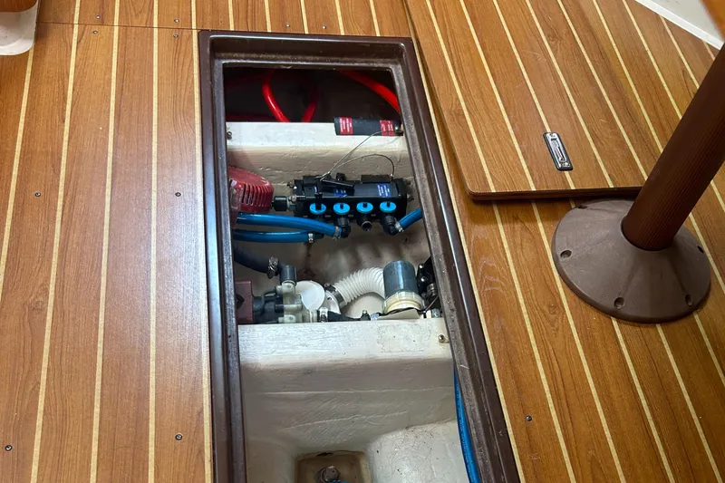 Dream Weaver Yacht Photos Pics Engine compartment of a 2003 Catalina 350 sailboat with visible hoses and components.