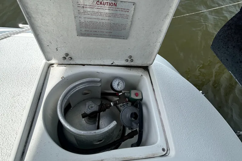 Dream Weaver Yacht Photos Pics Open propane tank compartment on a 2003 Catalina 350 boat, showing gauge and connections.