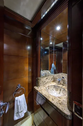 Seascape V Yacht Photos Pics Luxurious bathroom in 2005 Benetti Vision 145 yacht with marble sink and wooden paneling.