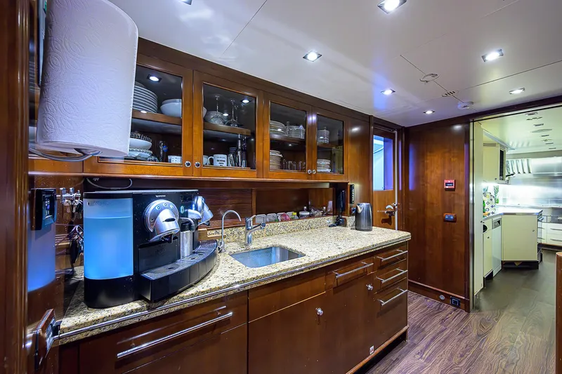 Seascape V Yacht Photos Pics Luxurious kitchen interior on a 2005 Benetti Vision 145 yacht, featuring modern appliances and wood cabinetry.