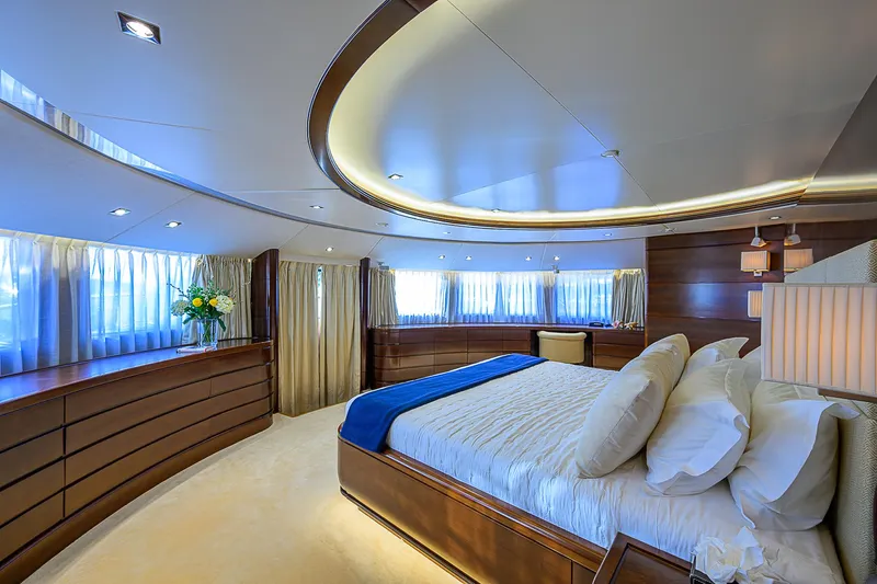 Seascape V Yacht Photos Pics Luxurious bedroom interior on 2005 Benetti Vision 145 yacht, featuring elegant wood finishes and modern lighting.