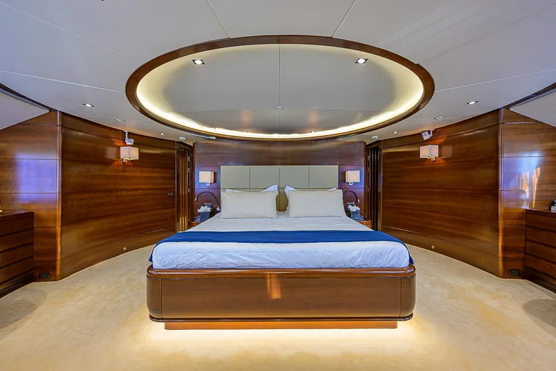 Seascape V Yacht Photos Pics Luxurious bedroom interior on 2005 Benetti Vision 145 yacht, featuring elegant wood paneling and modern lighting.