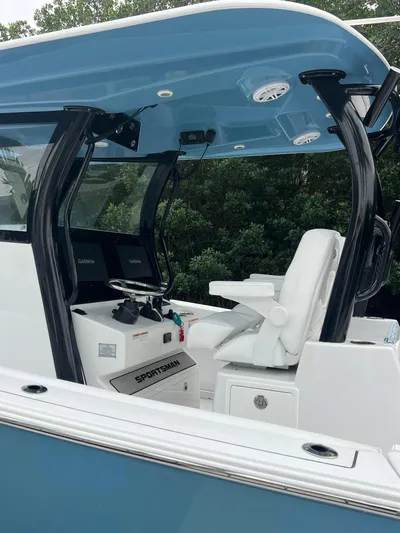  Yacht Photos Pics 2023 Sportsman Open 302 Center Console boat interior with blue canopy and white seating.